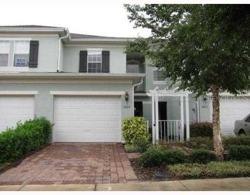 5923 Strada Capri Way, Unit 33 Orlando, FL 32835 - Photo 1 of 1 a front view of a house with a yard and garage