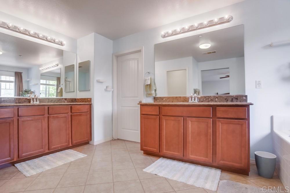 620 Key Lime Way Escondido, CA 92027 - Photo 12 of 24 a bathroom with a granite countertop sink and a mirror