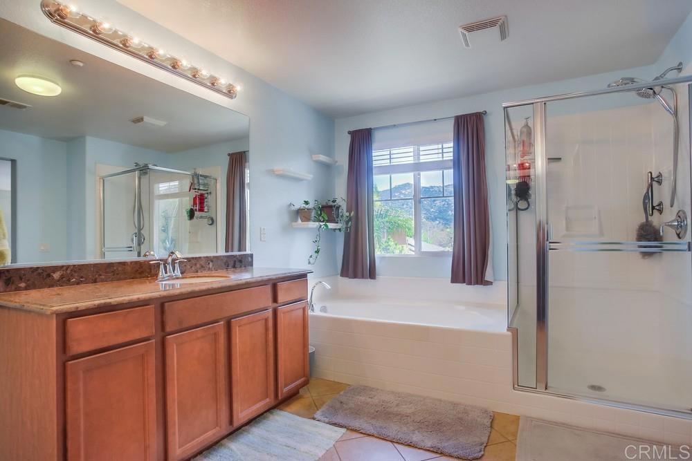 620 Key Lime Way Escondido, CA 92027 - Photo 13 of 24 a bathroom with a granite countertop sink and a mirror