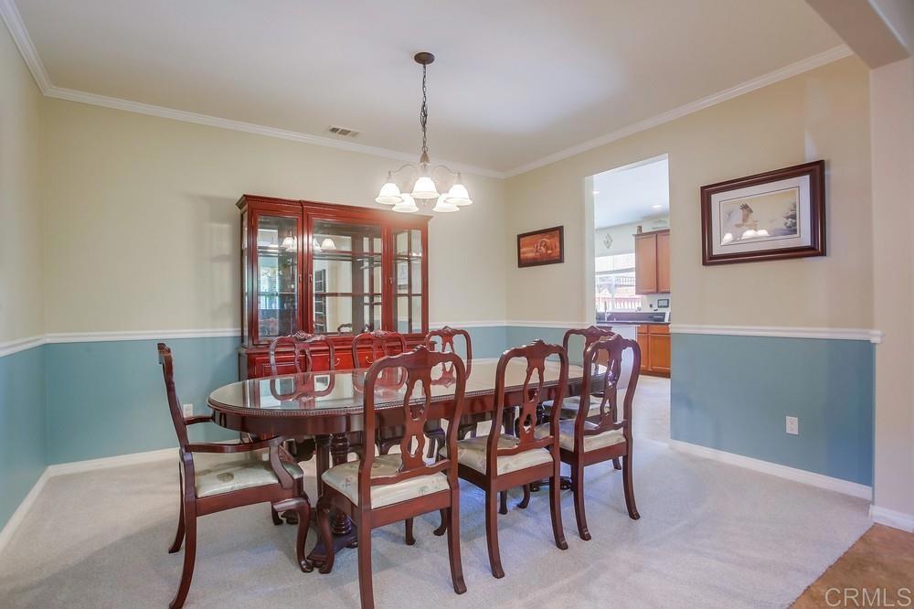 620 Key Lime Way Escondido, CA 92027 - Photo 3 of 24 a view of a dining room with furniture window and chandelier