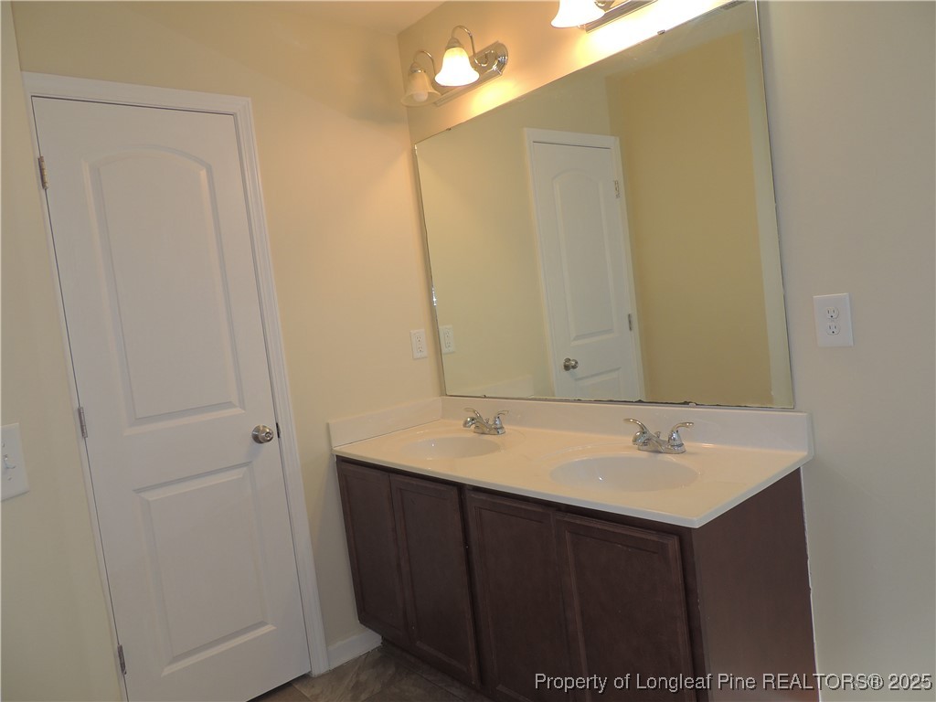 46 Hallow Oak Street Spring Lake, NC 28390 - Photo 20 of 22 a bathroom with a sink vanity and a mirror