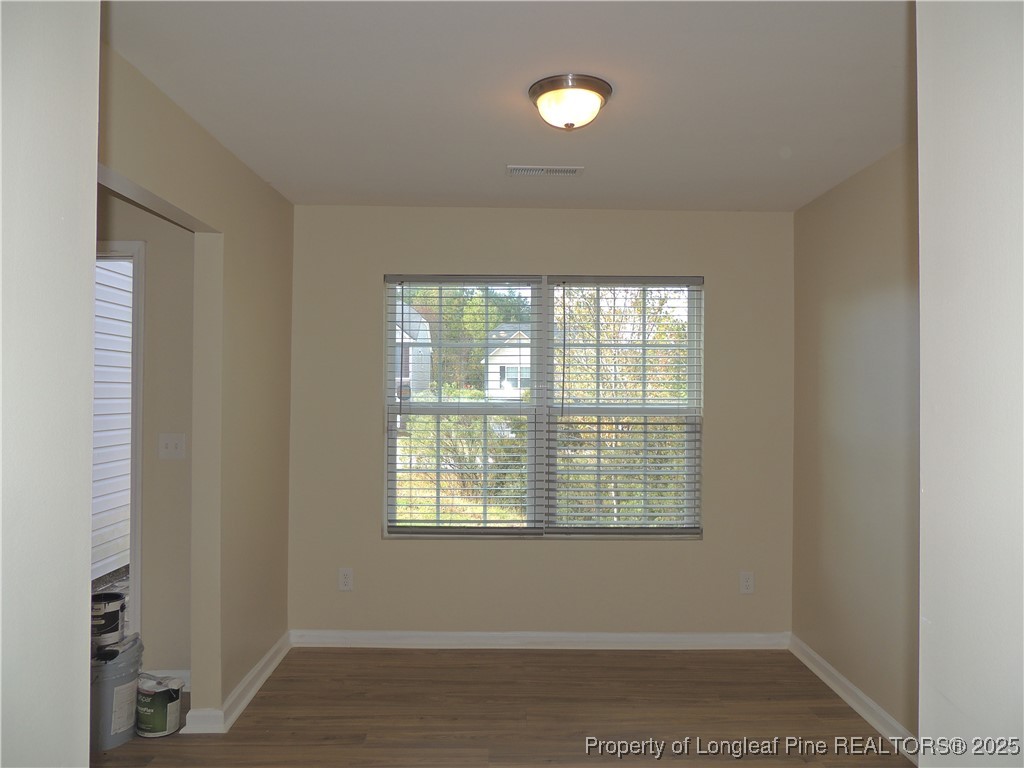 46 Hallow Oak Street Spring Lake, NC 28390 - Photo 21 of 22 a view of an empty room with wooden floor and a window