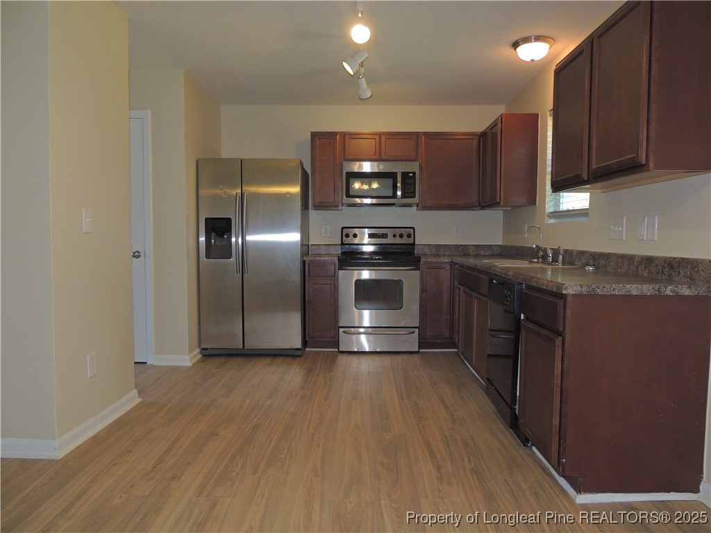 46 Hallow Oak Street Spring Lake, NC 28390 - Photo 4 of 22 a kitchen with stainless steel appliances granite countertop a stove a sink and a refrigerator