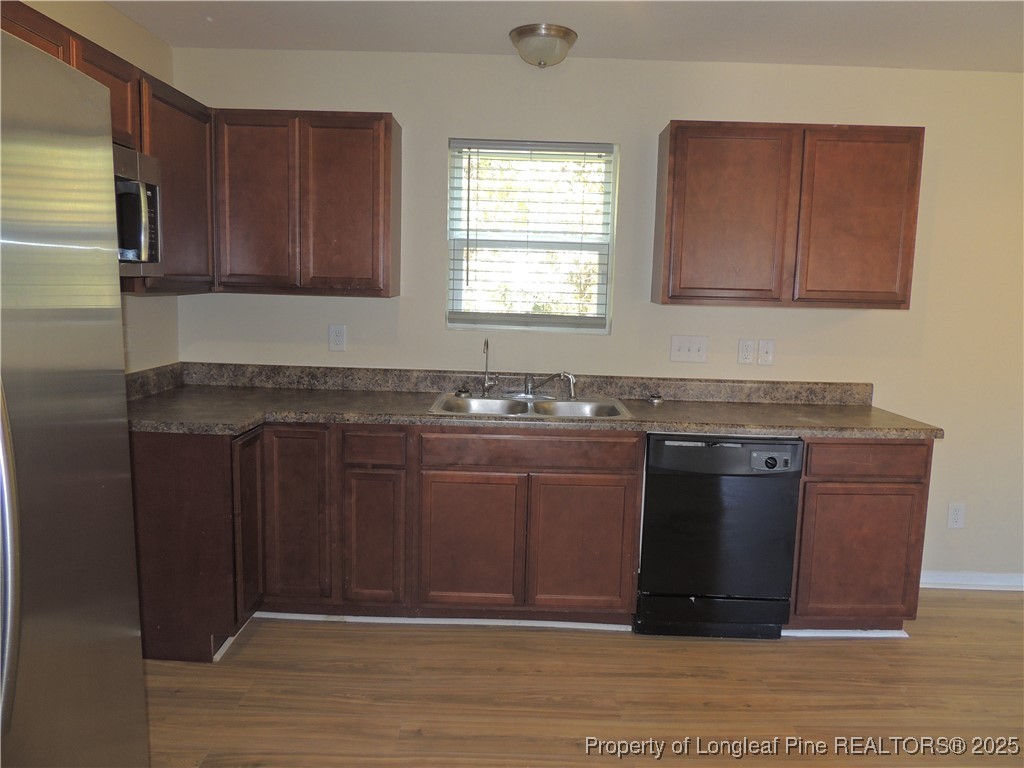 46 Hallow Oak Street Spring Lake, NC 28390 - Photo 6 of 22 a kitchen with granite countertop a sink cabinets and wooden floor