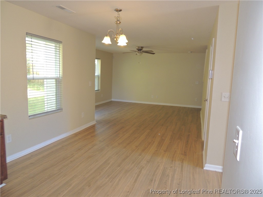 46 Hallow Oak Street Spring Lake, NC 28390 - Photo 8 of 22 an empty room with wooden floor and windows