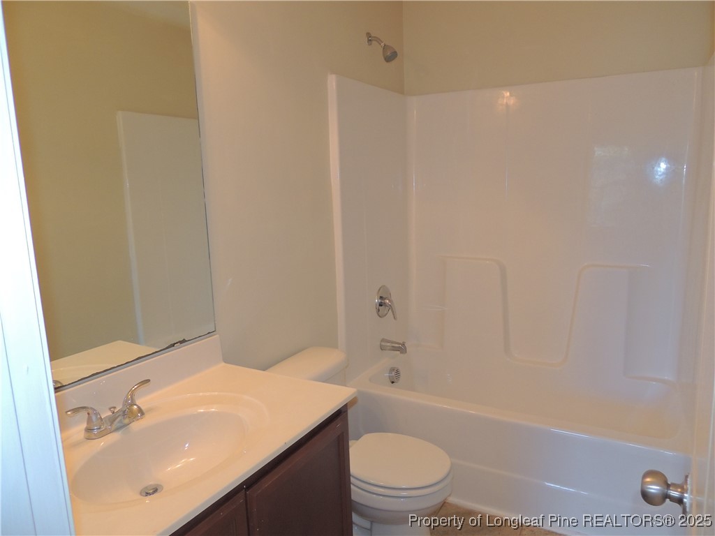 46 Hallow Oak Street Spring Lake, NC 28390 - Photo 10 of 22 a bathroom with a sink a toilet and shower