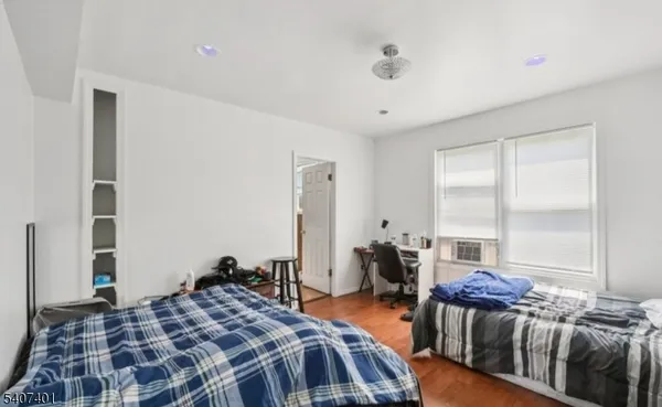 a bedroom with bed and a large window