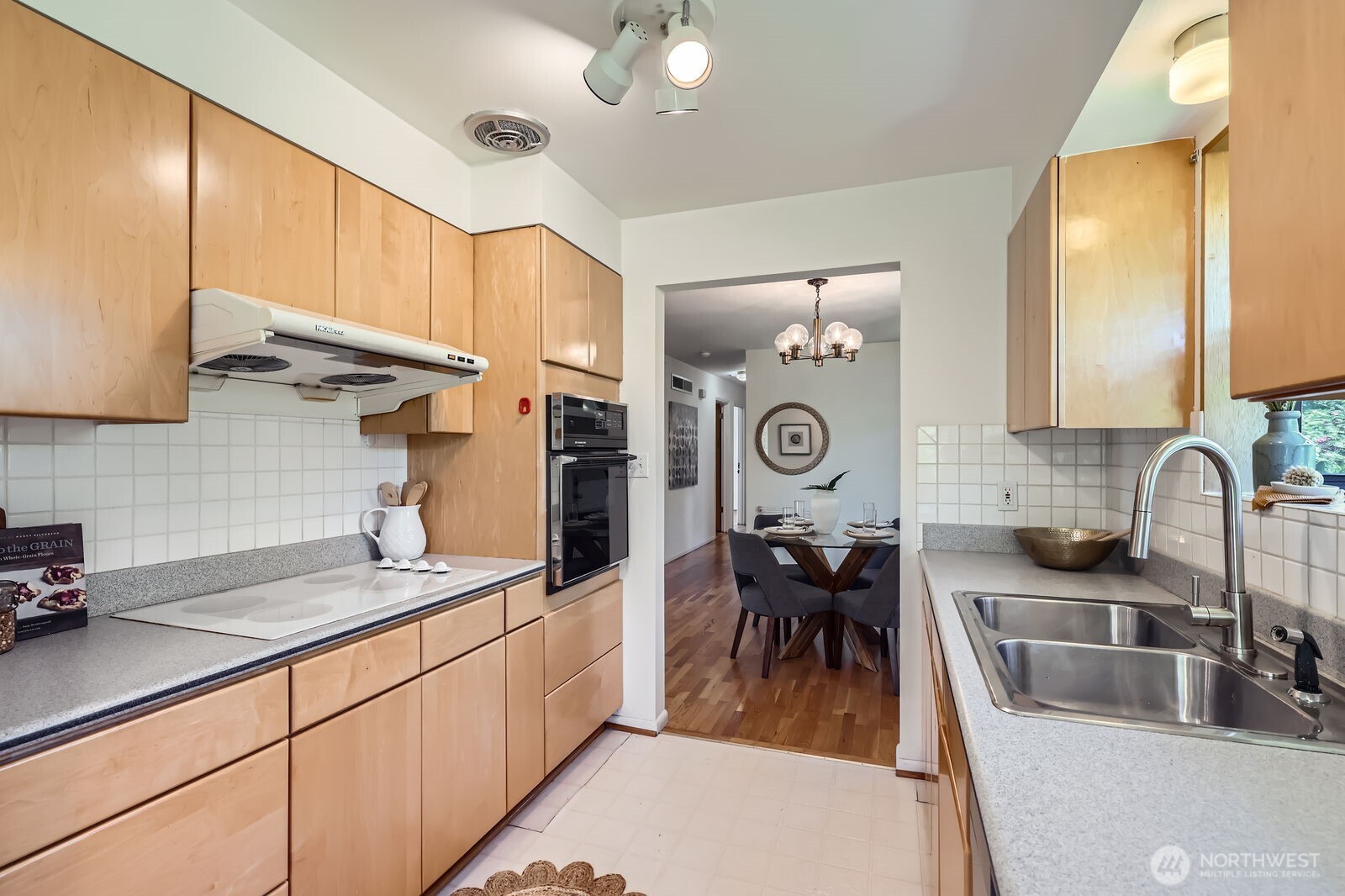 7924 South 112th Street Seattle, WA 98178 - Photo 11 of 40 a kitchen with stainless steel appliances granite countertop a sink dishwasher stove refrigerator and cabinets