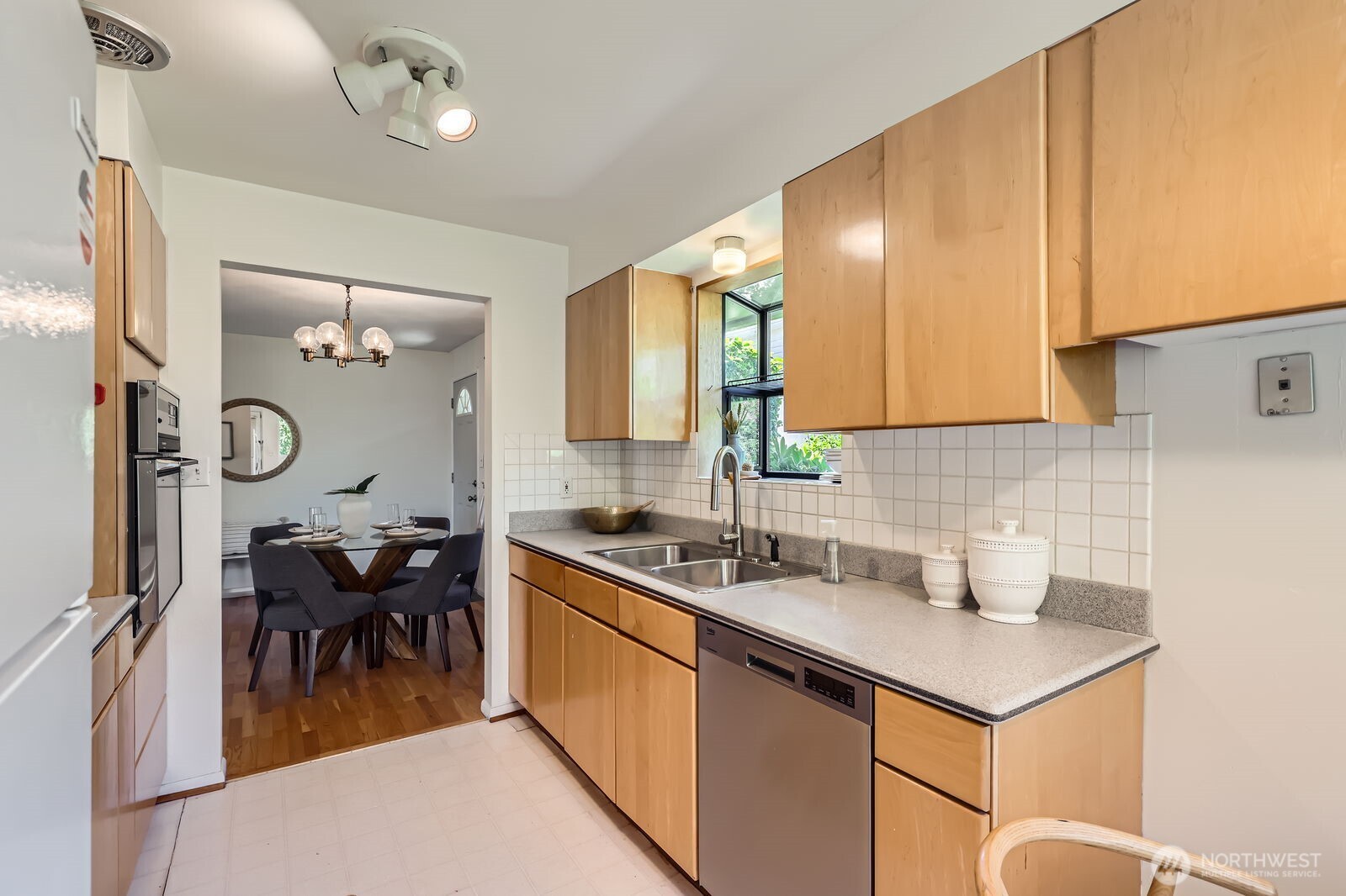 7924 South 112th Street Seattle, WA 98178 - Photo 12 of 40 a kitchen with a sink dining table and chairs