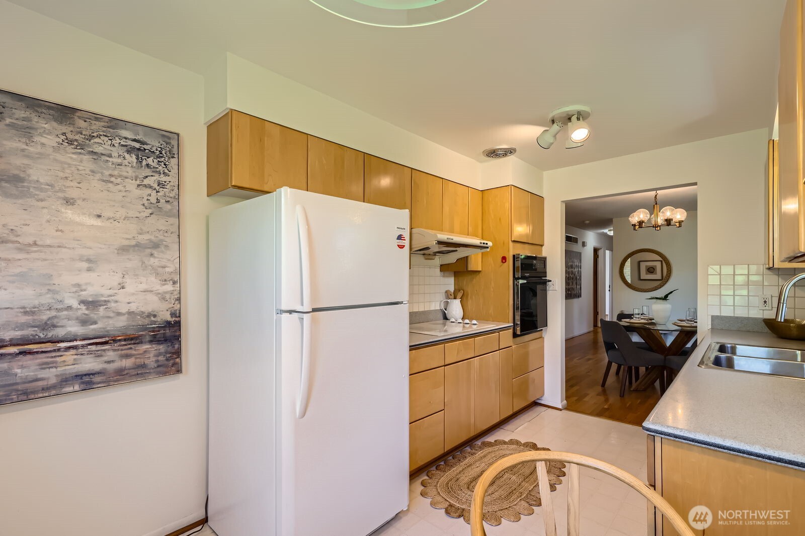 7924 South 112th Street Seattle, WA 98178 - Photo 13 of 40 a white refrigerator freezer and a stove sitting inside of a kitchen