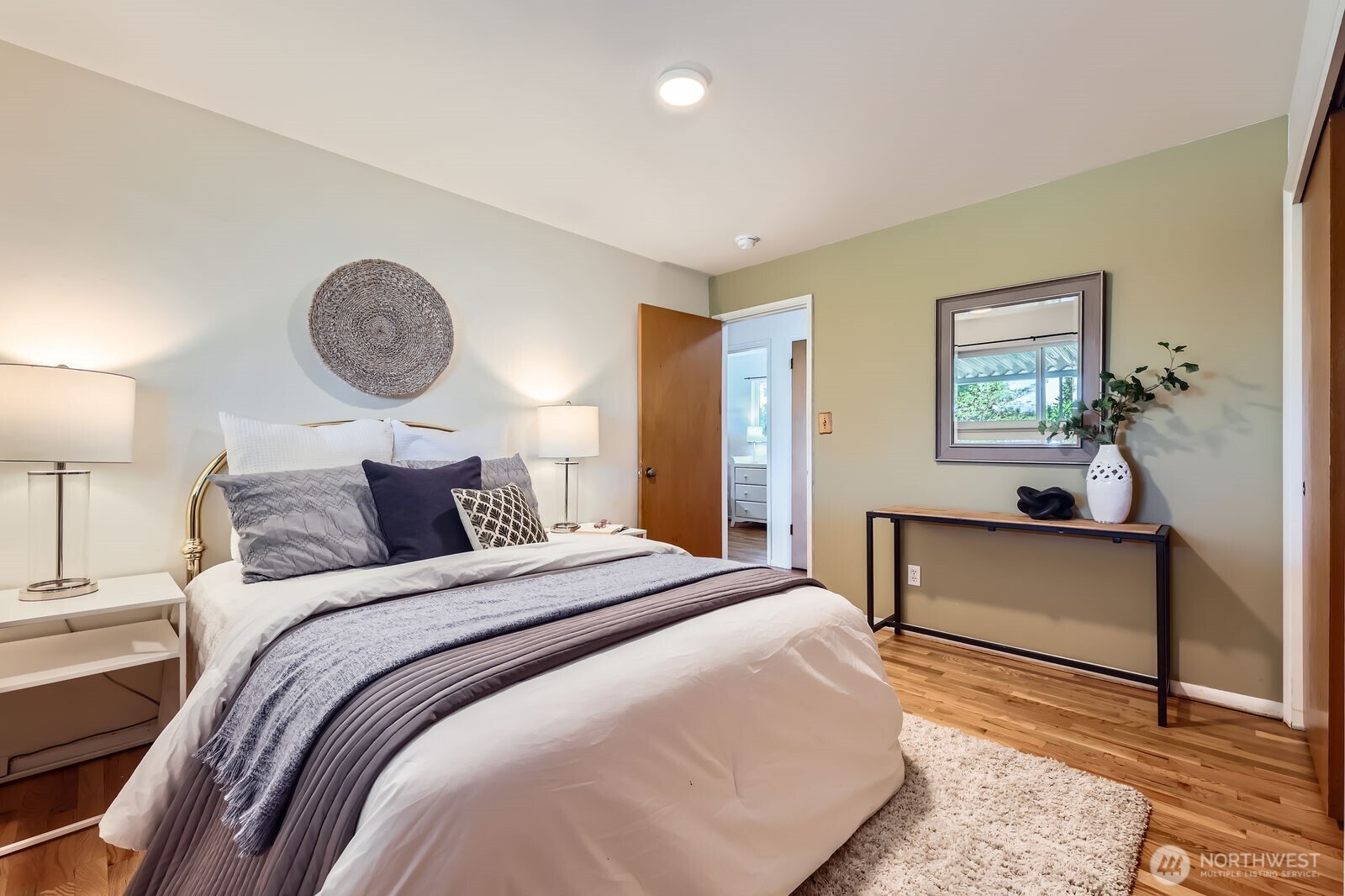 7924 South 112th Street Seattle, WA 98178 - Photo 15 of 40 a bedroom with a bed and a lamp on dresser