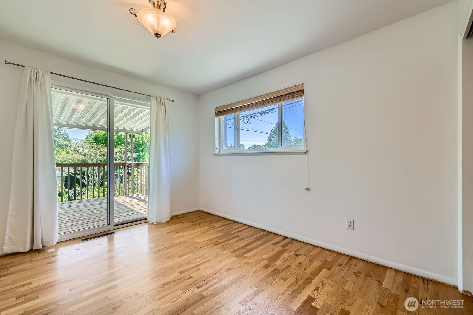 7924 South 112th Street Seattle, WA 98178 - Photo 18 of 40 a view of an empty room with wooden floor and a window