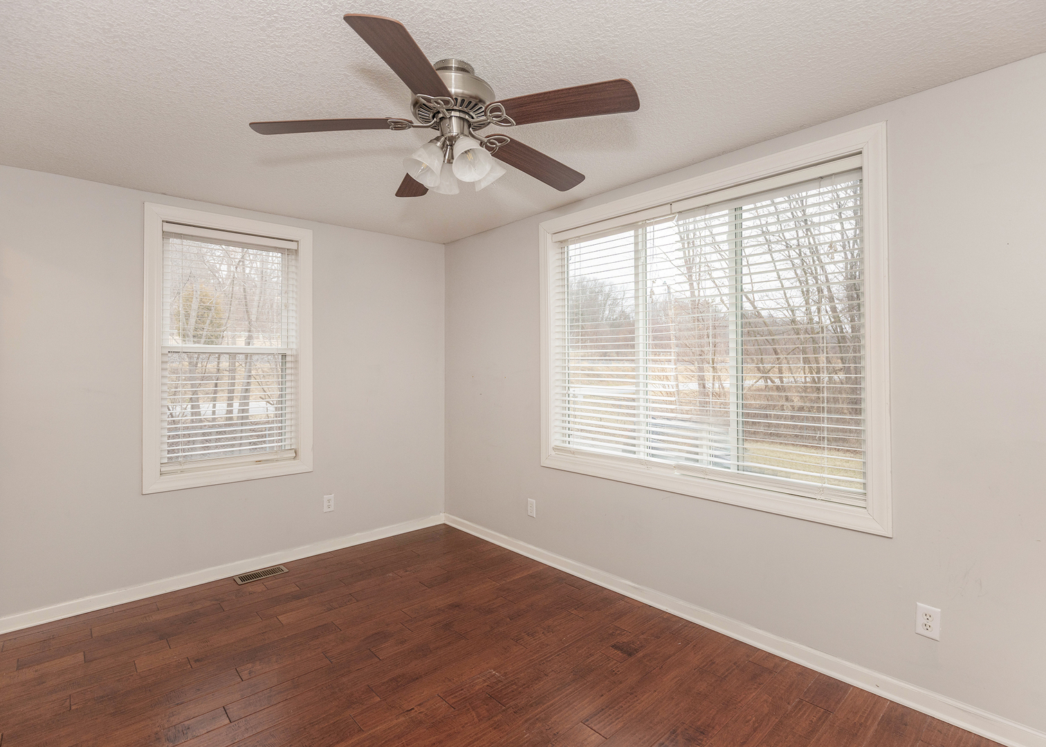 25199 182nd Street Pleasant Valley, IA 52767 - Photo 14 of 37 a view of an empty room with wooden floor and a window