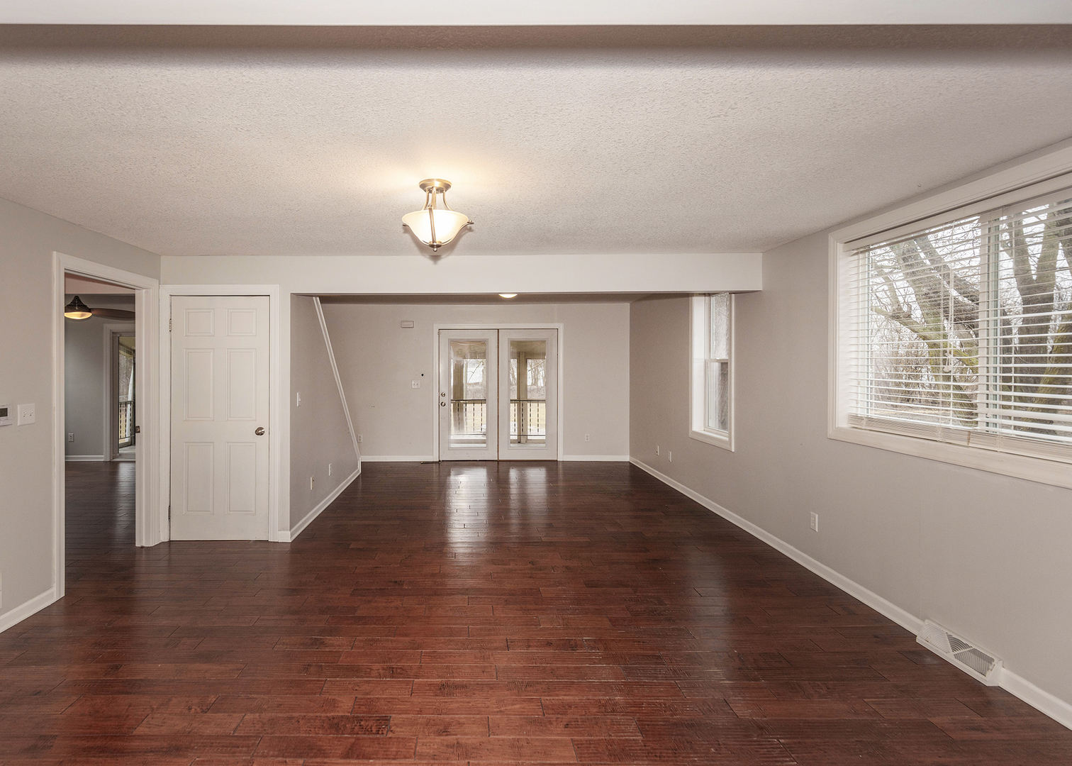 25199 182nd Street Pleasant Valley, IA 52767 - Photo 4 of 37 a view of an empty room with a window and wooden floor