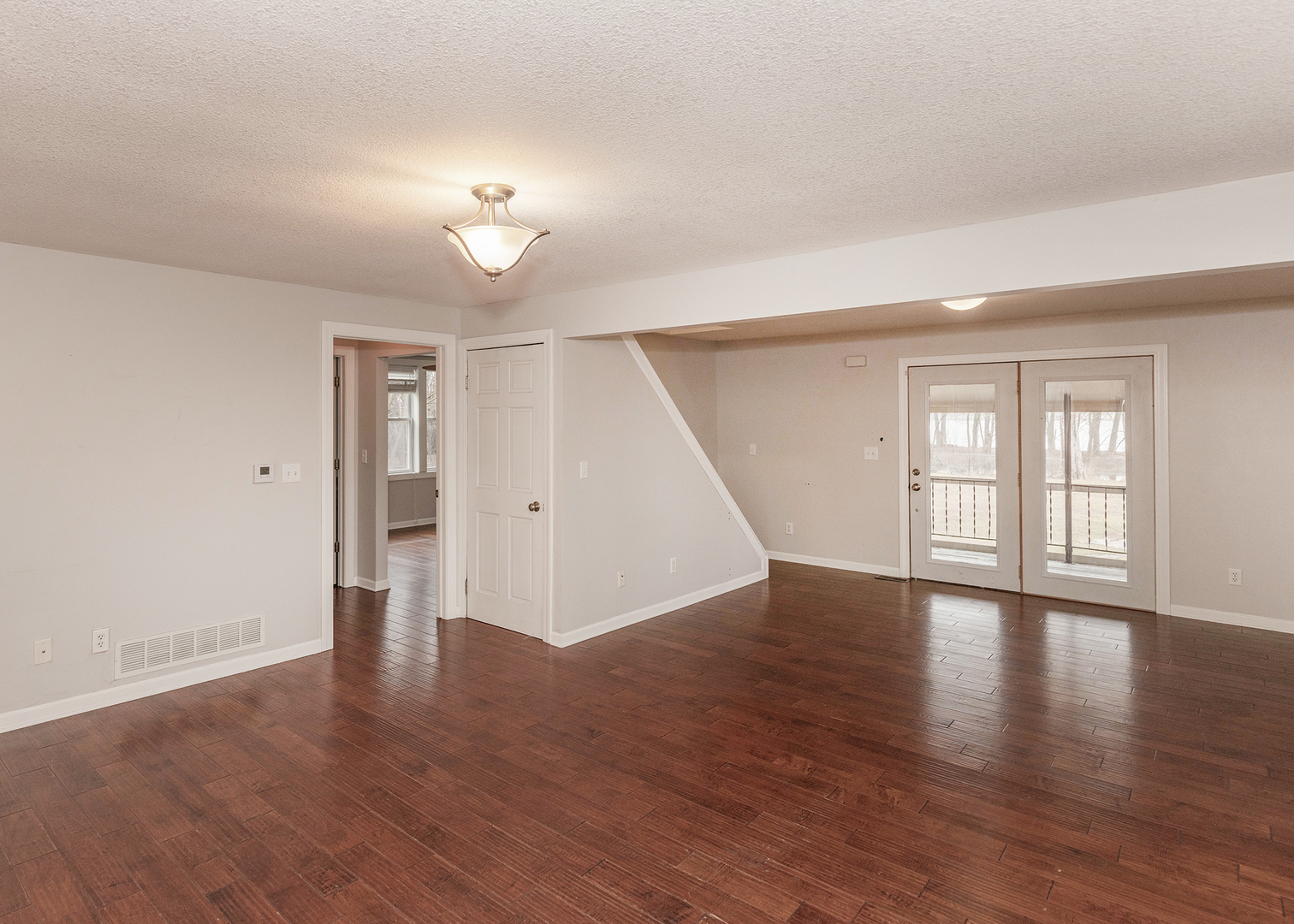 25199 182nd Street Pleasant Valley, IA 52767 - Photo 5 of 37 a view of an empty room with wooden floor and a window