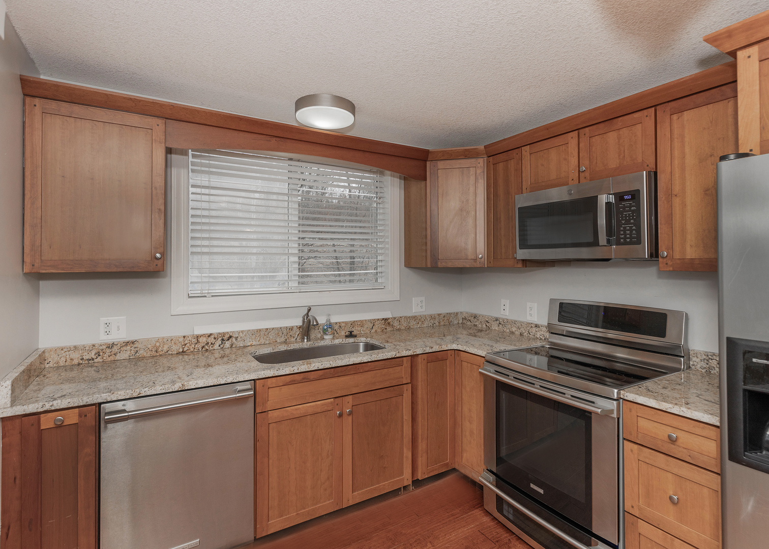 25199 182nd Street Pleasant Valley, IA 52767 - Photo 8 of 37 a kitchen with stainless steel appliances granite countertop a sink stove and microwave