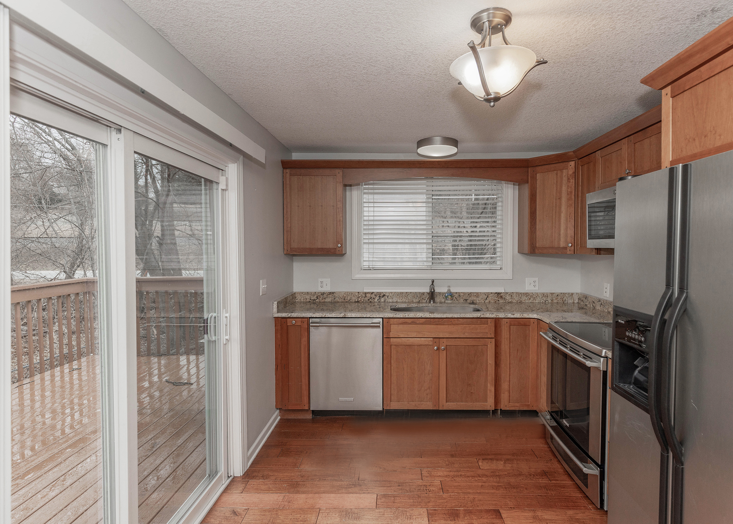 25199 182nd Street Pleasant Valley, IA 52767 - Photo 9 of 37 a kitchen with stainless steel appliances granite countertop a refrigerator a sink a stove and cabinets