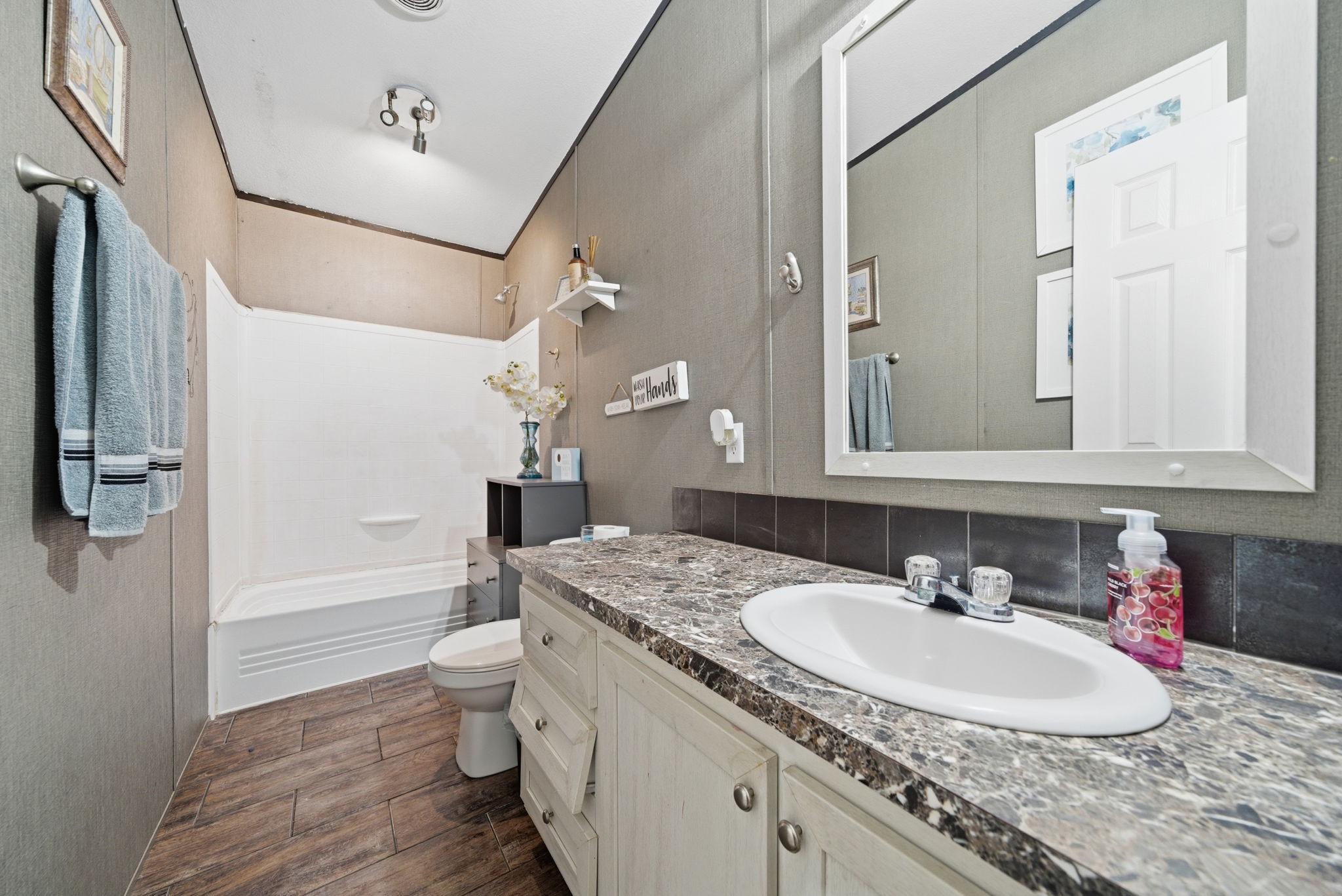 17028 Lively Road Waller, TX 77484 - Photo 10 of 20 a bathroom with a granite countertop sink a toilet and shower