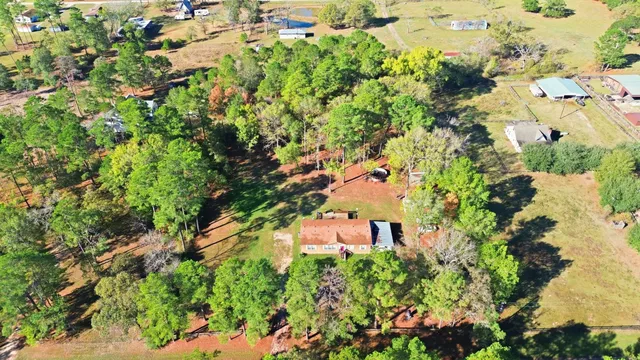 an aerial view of a house with a yard