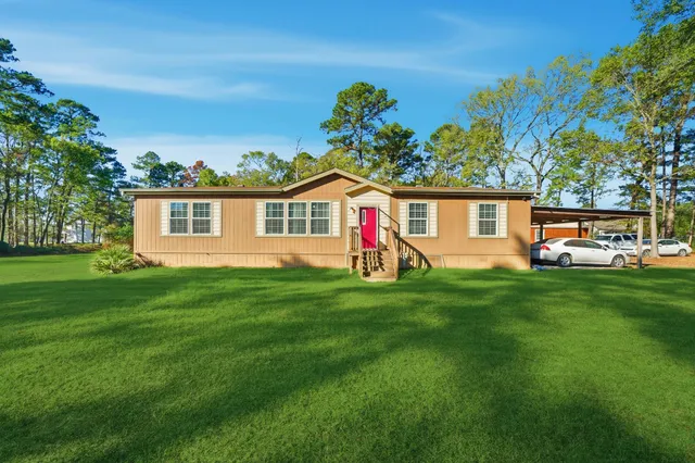 a front view of house with yard and green space