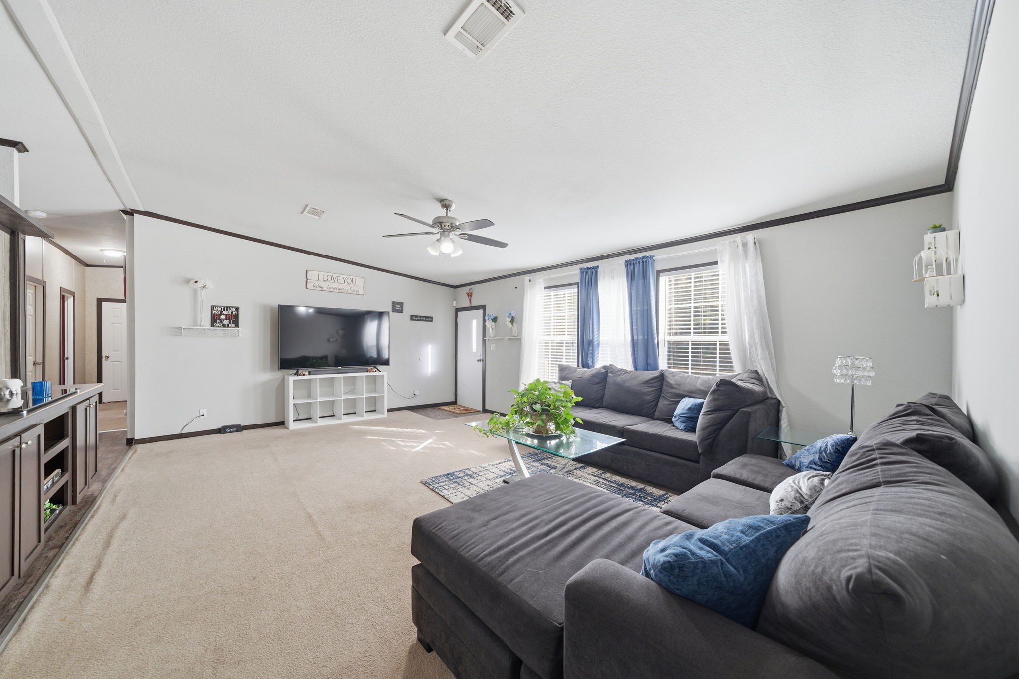 17028 Lively Road Waller, TX 77484 - Photo 3 of 20 a living room with furniture a large window and a flat screen tv
