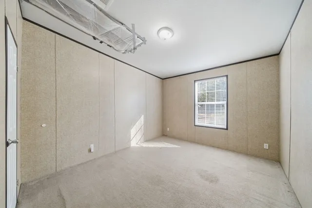 a bed room with a bed and a window