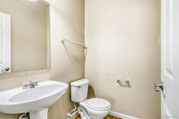 a bathroom with a sink toilet and a mirror