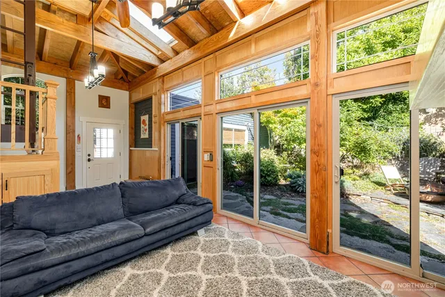 a living room with furniture and large windows