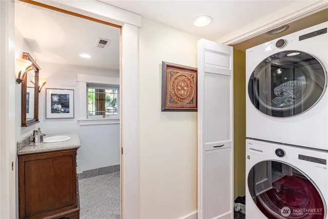 a bathroom with a granite countertop sink mirror and a shower