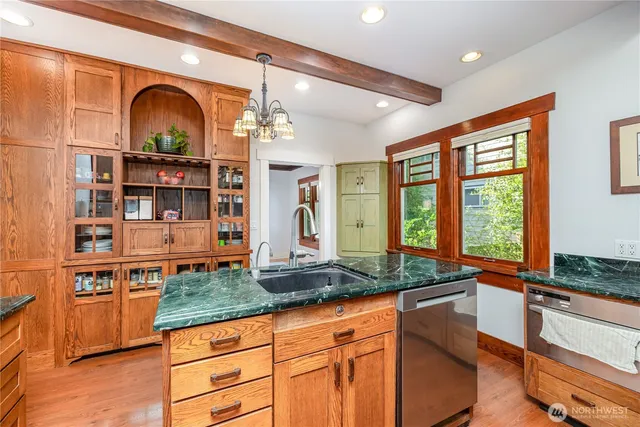 a kitchen with stainless steel appliances granite countertop a stove and a sink