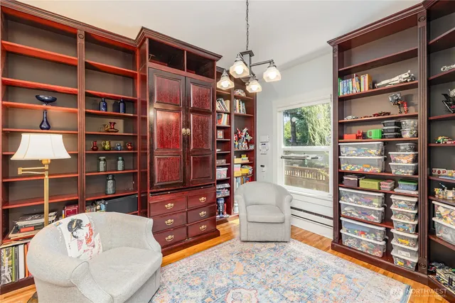 a living room with furniture and a book shelf