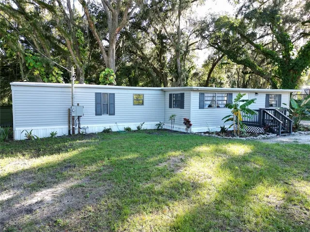 a view of backyard with outdoor seating and green space