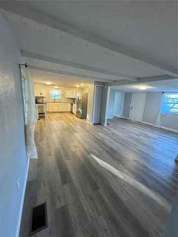 a view of a room with wooden floor