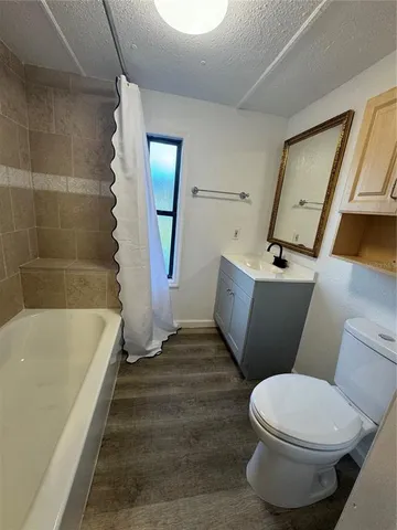 a bathroom with a bathtub and toilet