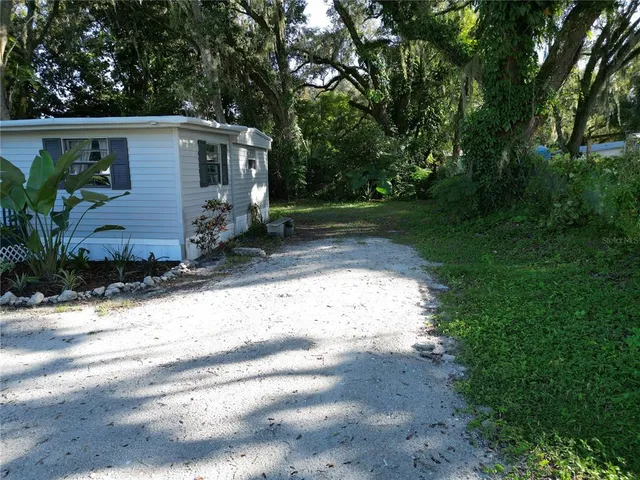 a view of house with backyard space and garden