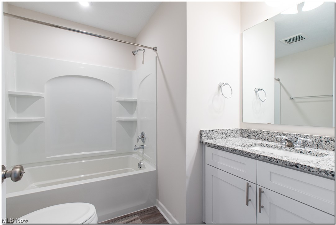 7701 Webster Road Middleburg Heights, OH 44130 - Photo 21 of 29 Full bathroom with hardwood / wood-style flooring, vanity, toilet, and shower / tub combination