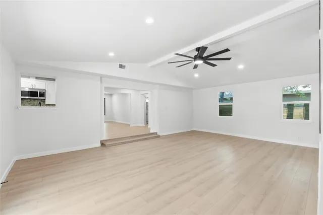 a living room with furniture a flat screen tv and a potted plant