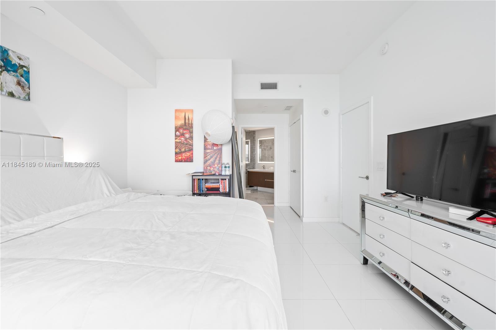 851 Northeast 1st Avenue, Unit 1410 Miami, FL 33132 - Photo 11 of 43 a bedroom with a bed and a flat screen tv