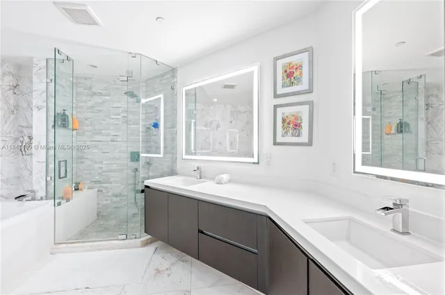 a bathroom with a sink mirror and a shower