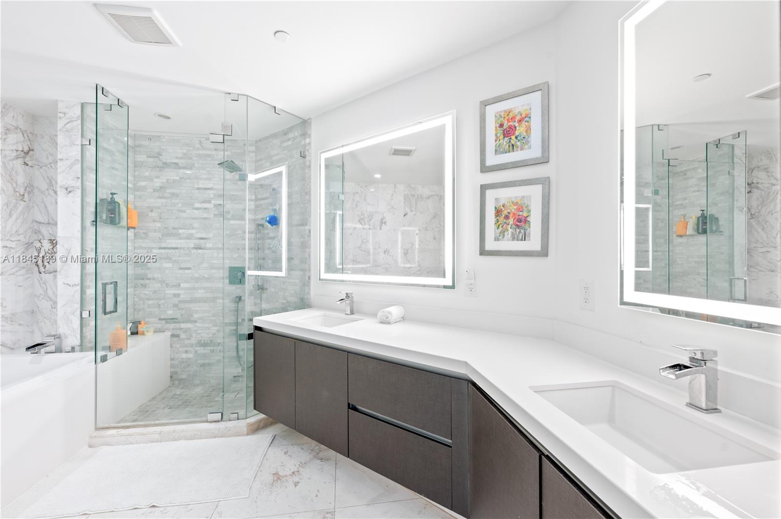 851 Northeast 1st Avenue, Unit 1410 Miami, FL 33132 - Photo 12 of 43 a bathroom with a sink mirror and a shower