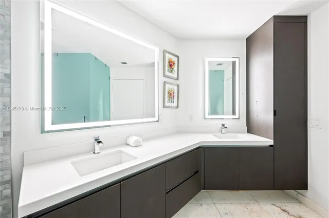 a bathroom with a double vanity sink mirror and