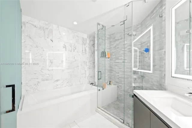 a bathroom with a sink mirror toilet and bathtub