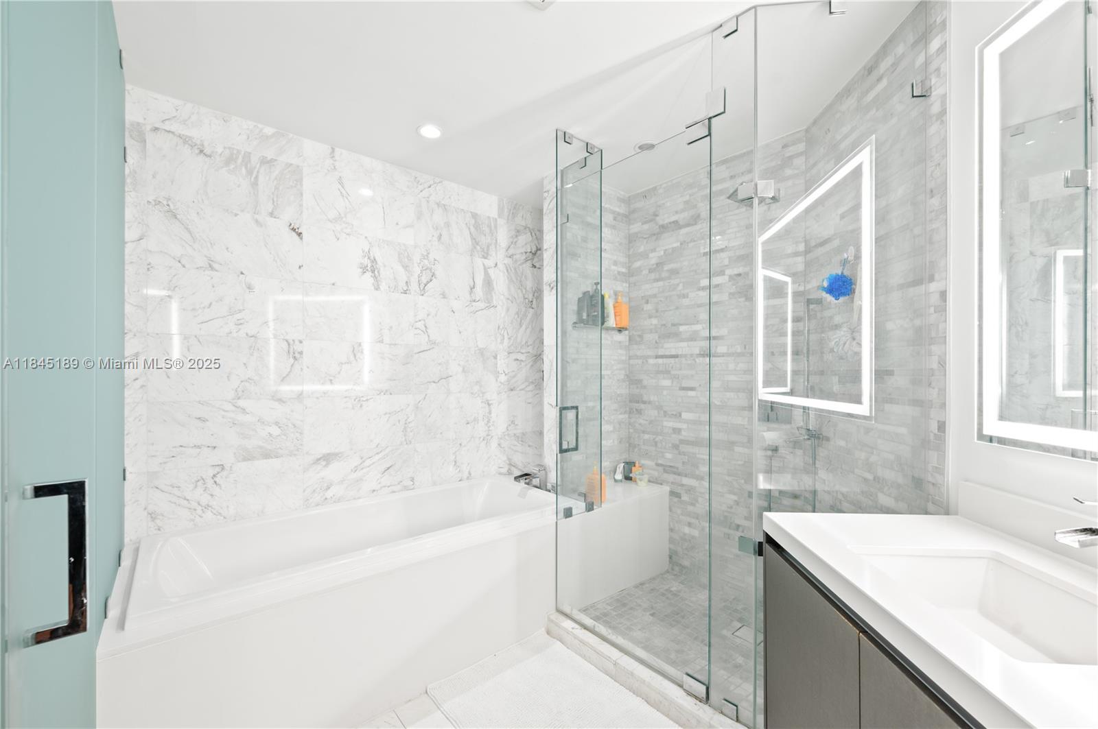 851 Northeast 1st Avenue, Unit 1410 Miami, FL 33132 - Photo 14 of 43 a bathroom with a sink mirror toilet and bathtub