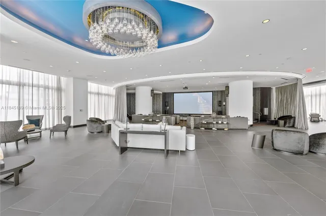 a living room with furniture and large windows