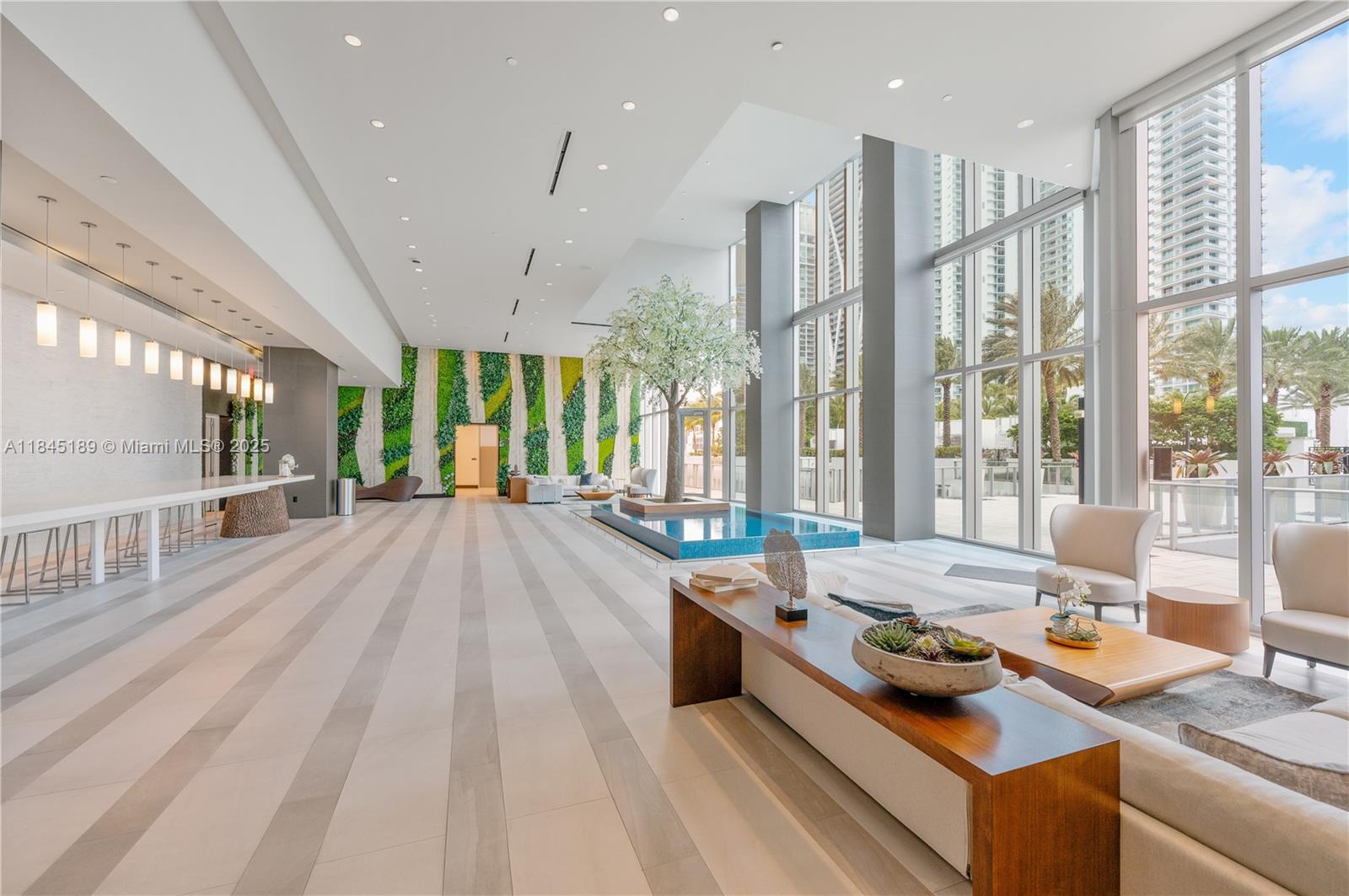 851 Northeast 1st Avenue, Unit 1410 Miami, FL 33132 - Photo 23 of 43 a living room with furniture and large windows