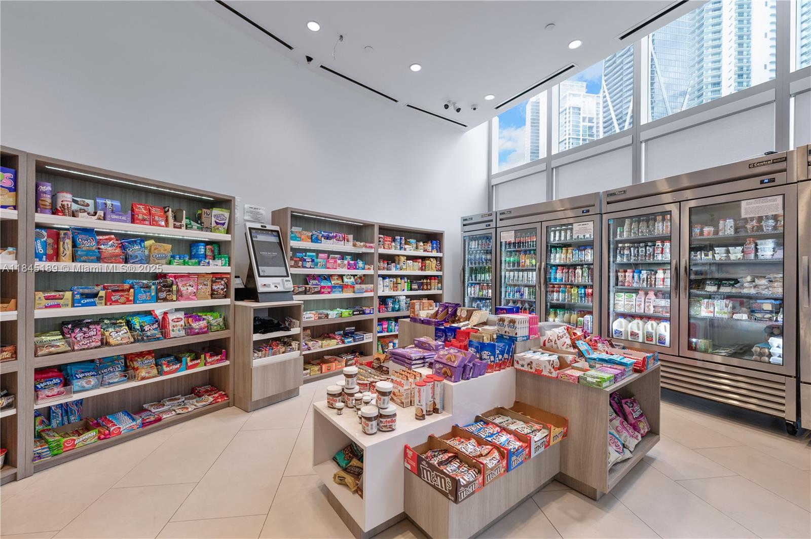 851 Northeast 1st Avenue, Unit 1410 Miami, FL 33132 - Photo 26 of 43 a living room with furniture a book shelf and a book shelf