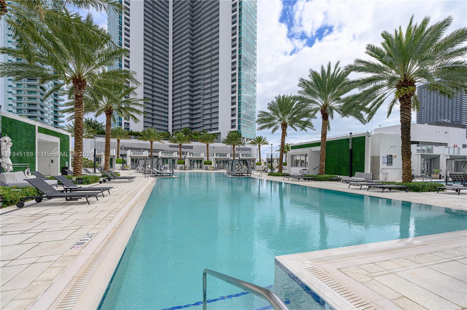 851 Northeast 1st Avenue, Unit 1410 Miami, FL 33132 - Photo 32 of 43 a view of a swimming pool with a table and chairs