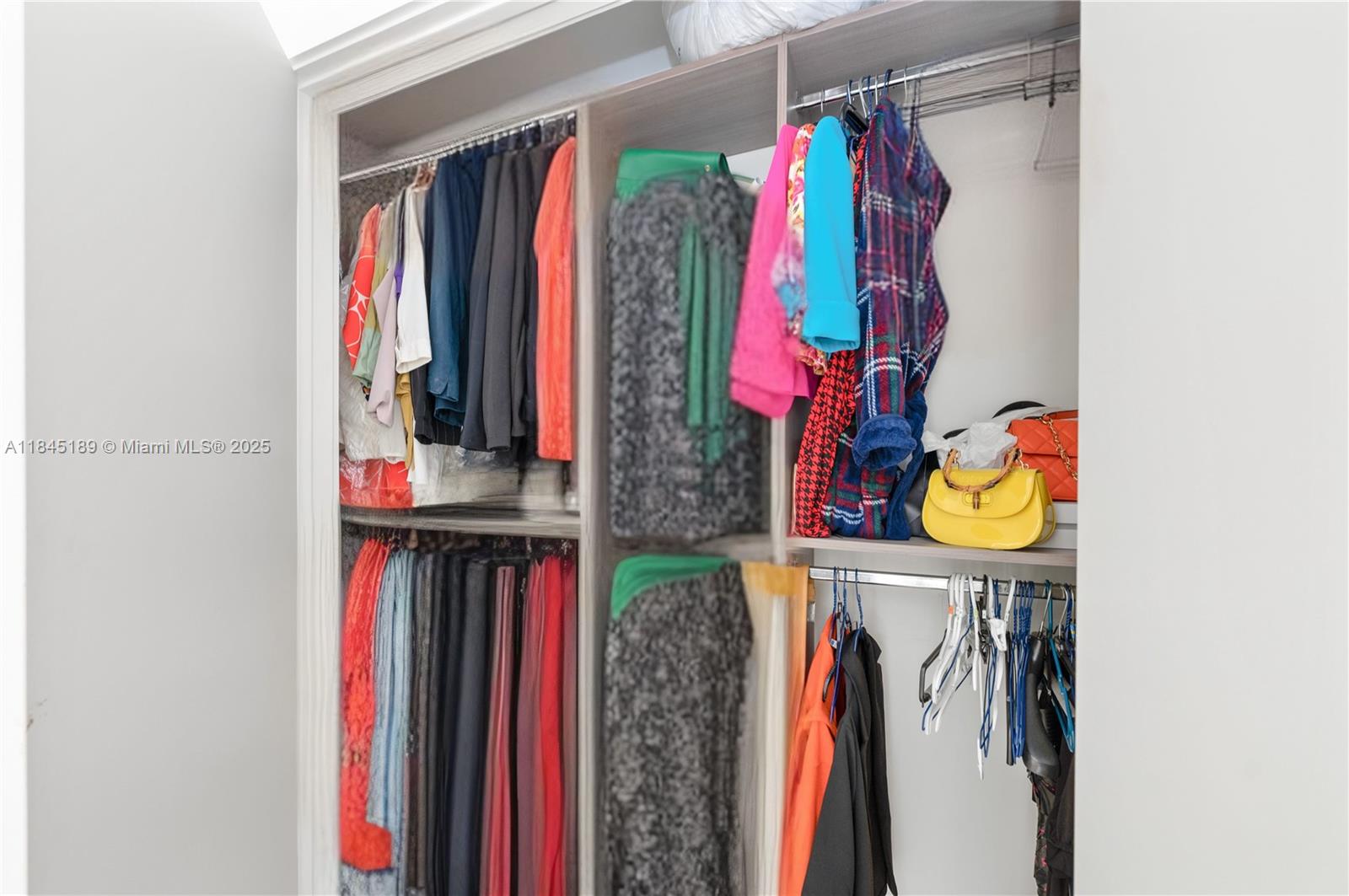 851 Northeast 1st Avenue, Unit 1410 Miami, FL 33132 - Photo 42 of 43 a view of walk in closet with clothes and shoes