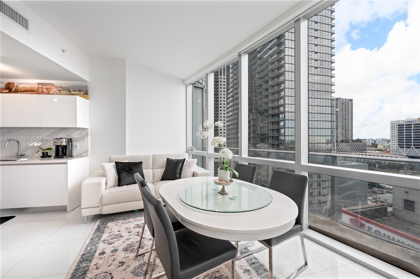 851 Northeast 1st Avenue, Unit 1410 Miami, FL 33132 - Photo 9 of 43 a living room with furniture and a window