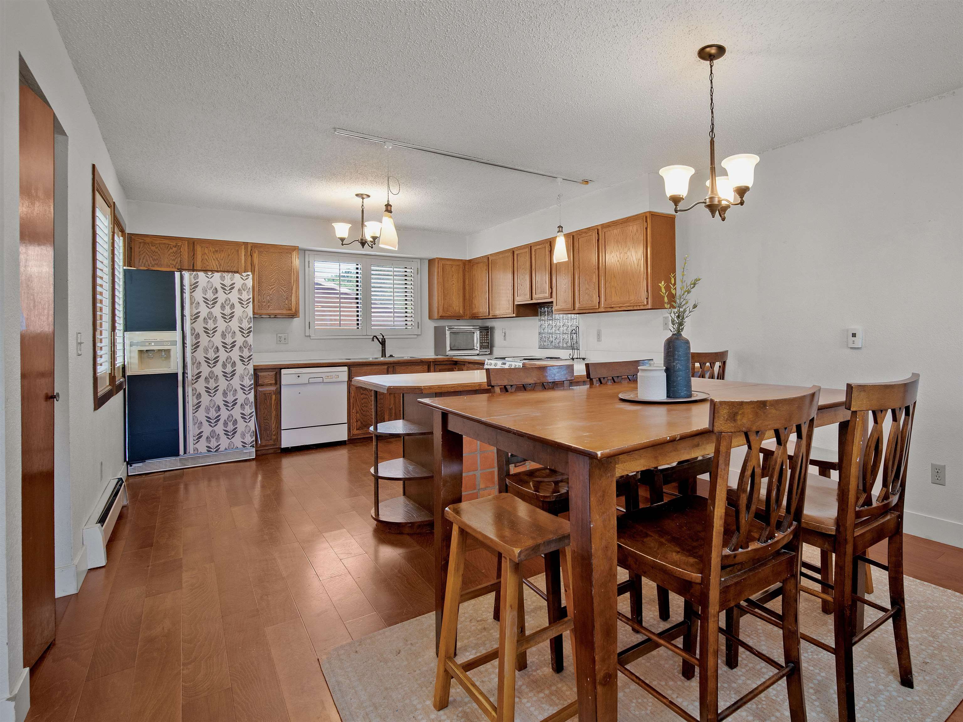 517 Rado Drive, Unit D Grand Junction, CO 81507 - Photo 3 of 24 a dining room with furniture a chandelier and wooden floor